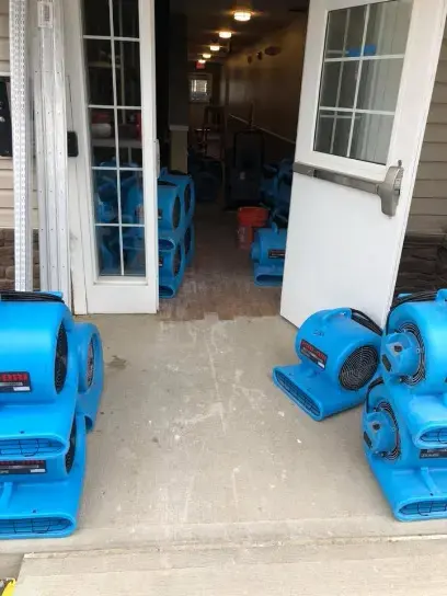 Rows of air movers lined up in a hallway during a North Port dry-out